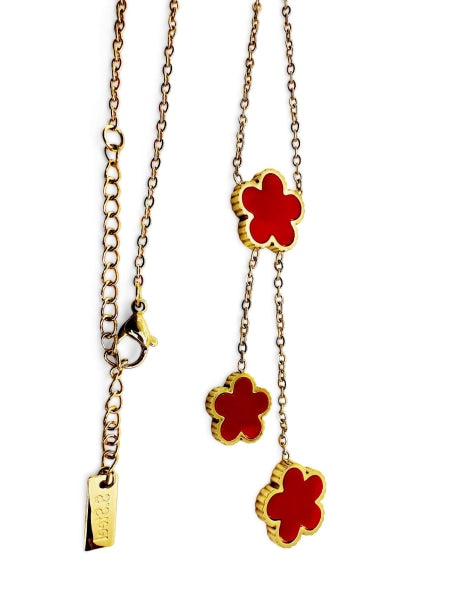 Golden colored 3 red clovers hanging necklace.